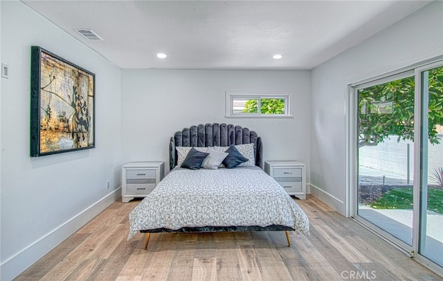 bedroom with access to outside and light hardwood / wood-style floors