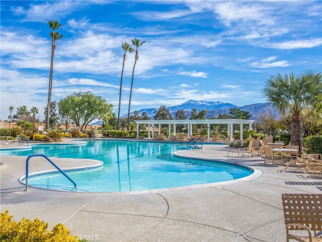 view of pool featuring a patio and a mountain view