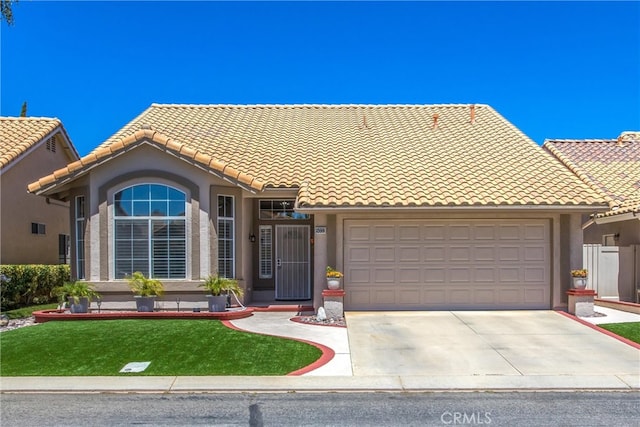 view of front of house with a garage and a front lawn