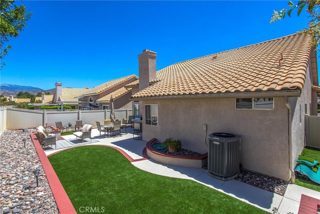 back of house featuring a yard, a pergola, a patio, and central AC