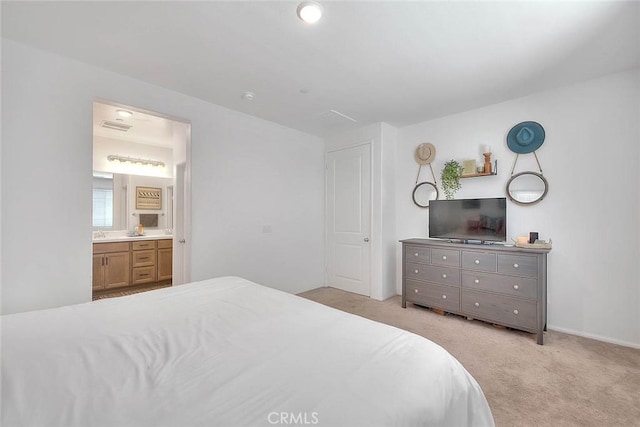 carpeted bedroom with ensuite bath