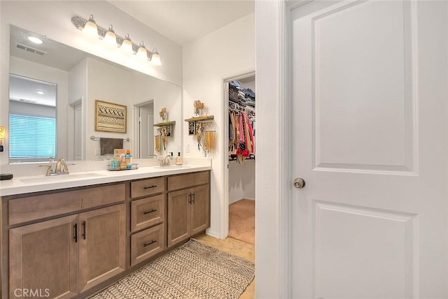 bathroom featuring tile patterned flooring and vanity