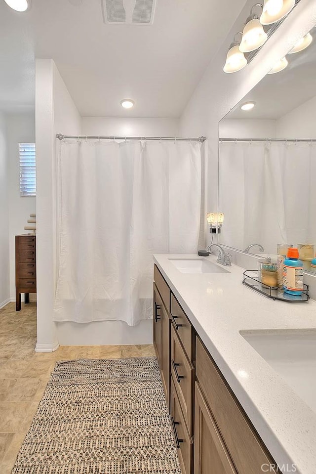 bathroom with vanity and curtained shower