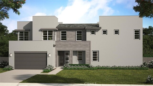 view of front of home featuring a garage and a front yard