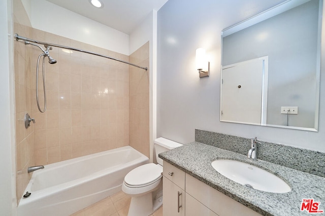 full bathroom featuring vanity, toilet, tiled shower / bath, and tile patterned flooring