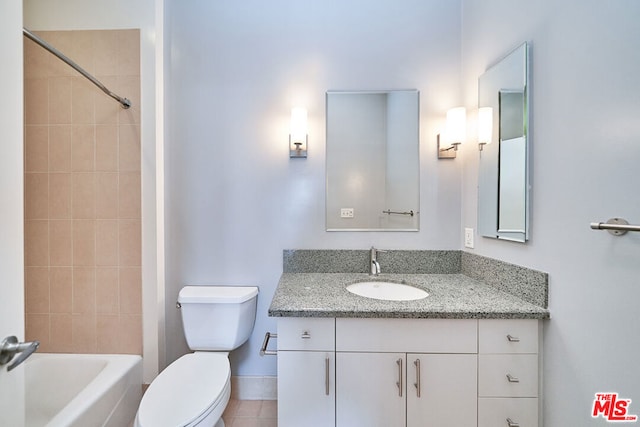 full bathroom featuring vanity, tile patterned flooring, tiled shower / bath, and toilet