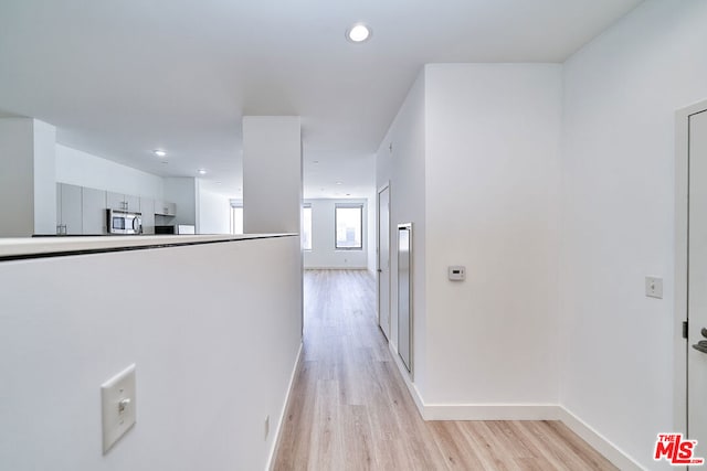 hall with light wood-type flooring