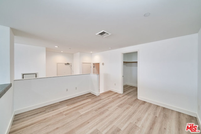 unfurnished room with light wood-type flooring