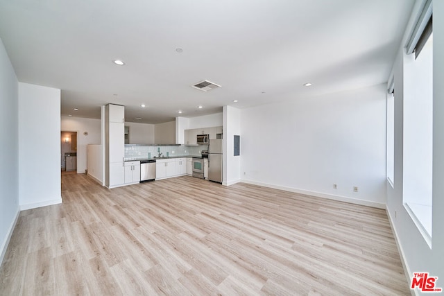 unfurnished living room with light wood-type flooring