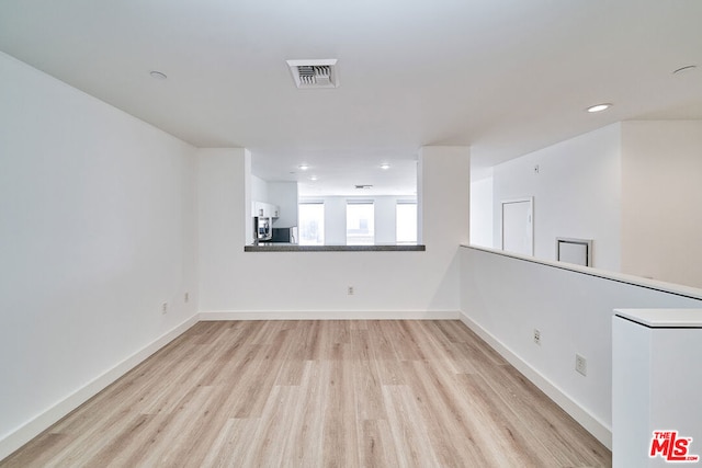 unfurnished room with light hardwood / wood-style flooring