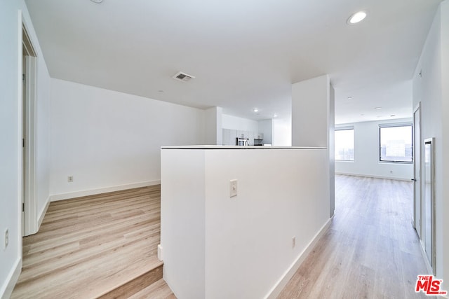 hall with light hardwood / wood-style floors