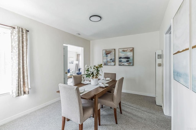 carpeted dining room featuring plenty of natural light