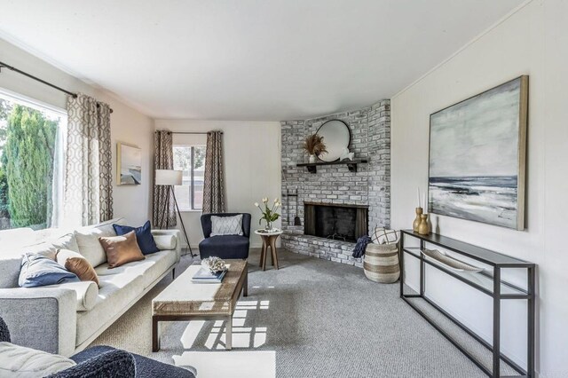 living room featuring carpet floors, brick wall, and a brick fireplace