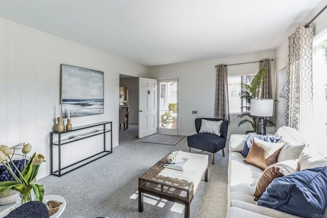 carpeted living room with a healthy amount of sunlight