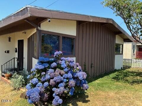 view of side of home featuring a yard