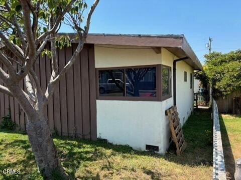 view of side of home featuring a yard