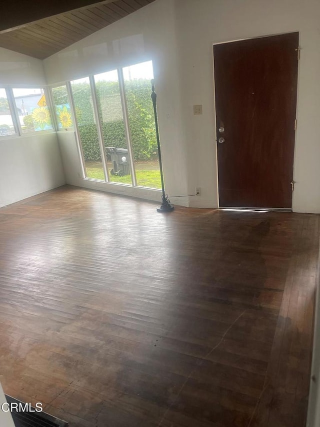 spare room with hardwood / wood-style flooring, vaulted ceiling with beams, plenty of natural light, and wooden ceiling