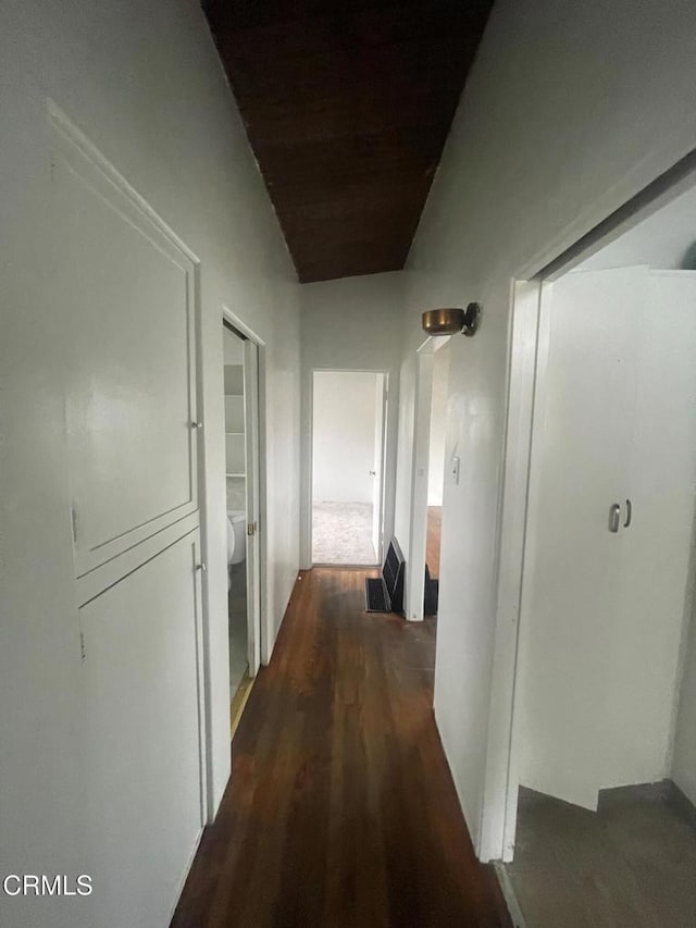 hallway with dark hardwood / wood-style flooring