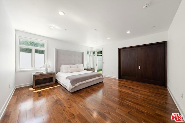 bedroom with dark hardwood / wood-style flooring