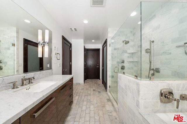 bathroom with an enclosed shower and vanity