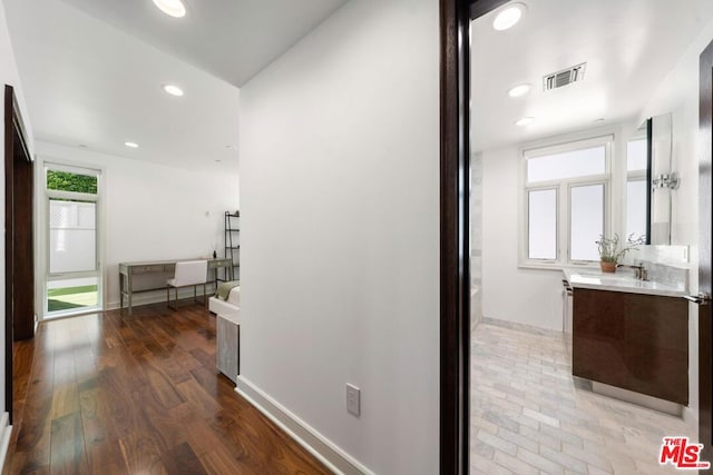 corridor featuring hardwood / wood-style floors