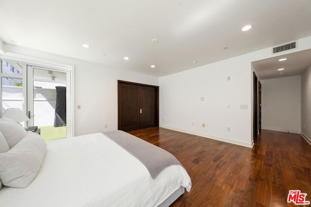 bedroom with access to exterior and dark hardwood / wood-style flooring