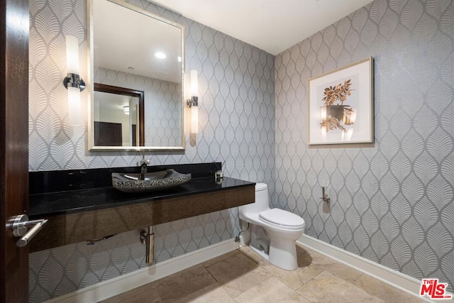 bathroom featuring sink, toilet, and tile patterned floors