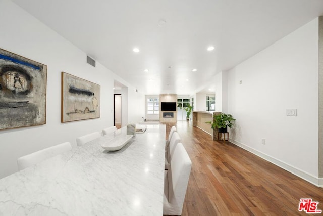 dining room featuring built in features and light hardwood / wood-style floors