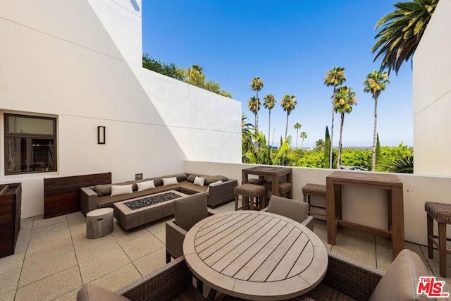 view of patio featuring an outdoor living space with a fire pit