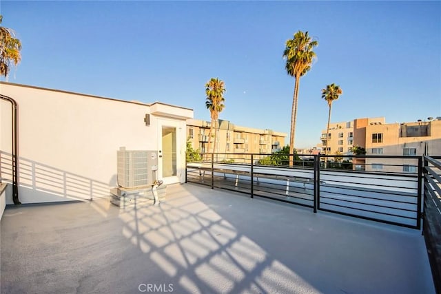 view of patio featuring a balcony and central air condition unit