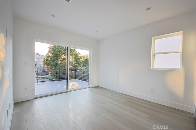 spare room with light wood-type flooring