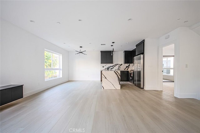 unfurnished living room featuring light hardwood / wood-style floors