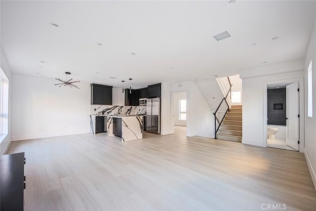 unfurnished living room featuring hardwood / wood-style flooring