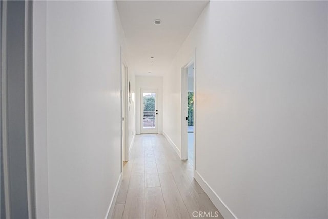 hallway with light hardwood / wood-style flooring