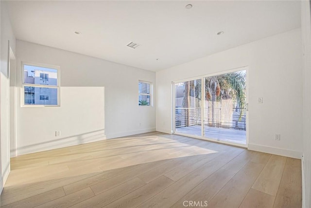 unfurnished room with light wood-type flooring