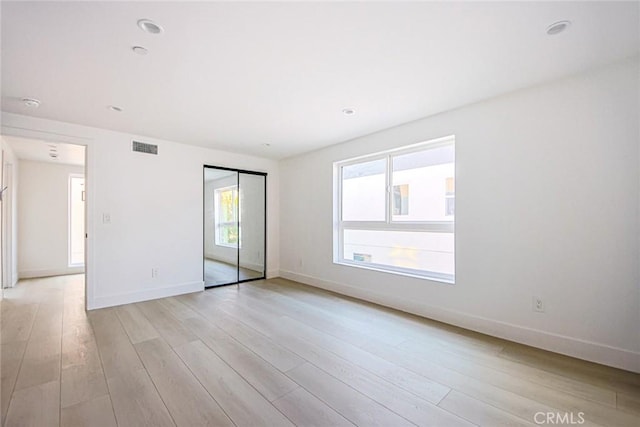 spare room with light hardwood / wood-style floors