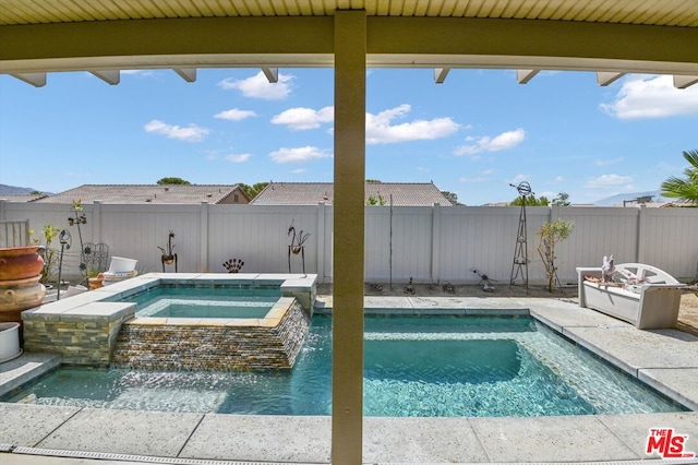 view of swimming pool featuring an in ground hot tub and pool water feature