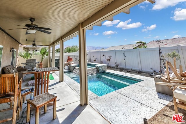 view of pool featuring a patio area, an in ground hot tub, and ceiling fan