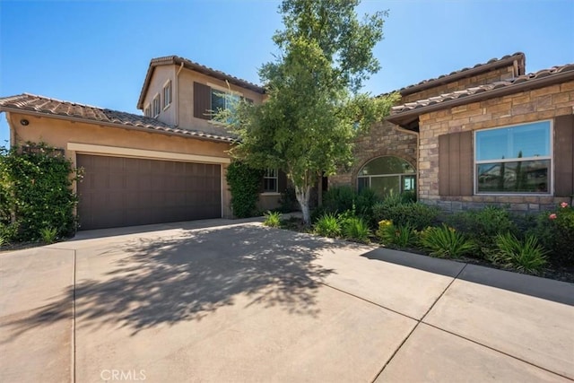 mediterranean / spanish house featuring a garage