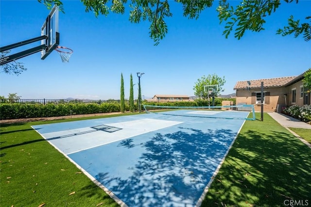 view of basketball court with a yard