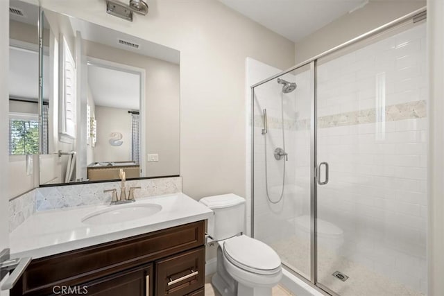 bathroom featuring toilet, vanity, and walk in shower