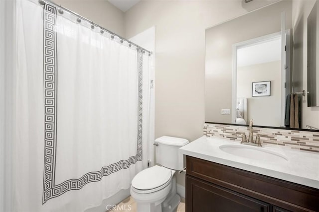 bathroom with vanity, tasteful backsplash, and toilet