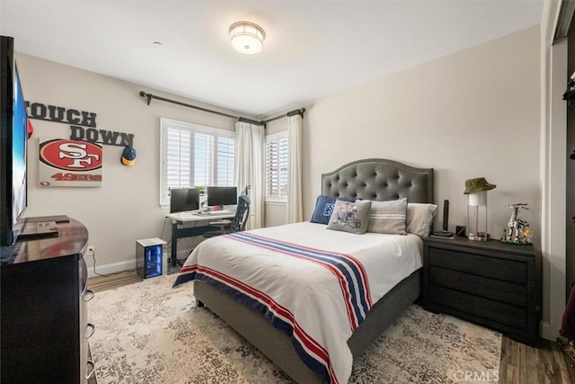 bedroom with hardwood / wood-style floors