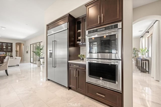 kitchen with dark brown cabinetry and stainless steel appliances