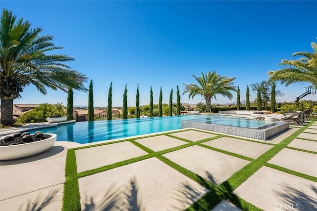 view of swimming pool with a patio