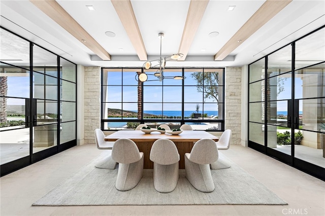 dining space featuring a wealth of natural light, beamed ceiling, an inviting chandelier, and french doors