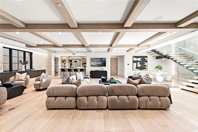 living room with light hardwood / wood-style floors and beamed ceiling