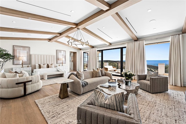 living room with a notable chandelier, light hardwood / wood-style flooring, a water view, and vaulted ceiling with beams