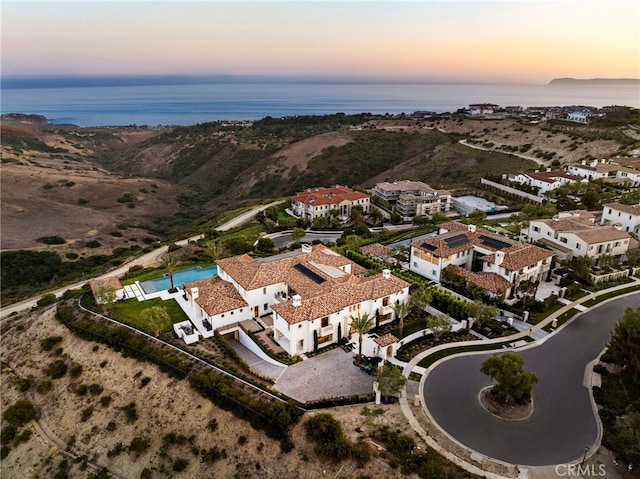 aerial view at dusk with a water view