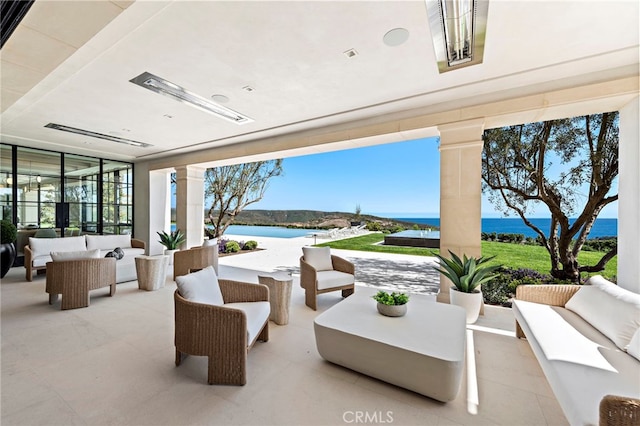 view of patio with an outdoor living space and a water view